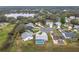 Aerial view of home in established neighborhood near a pond at 25110 Meriweather Rd, Leesburg, FL 34748