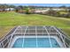 Aerial perspective showcasing pool within the screened enclosure and picturesque surroundings at 25110 Meriweather Rd, Leesburg, FL 34748