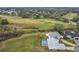 Aerial view of home showing the backyard with pool and the nearby golf course at 25110 Meriweather Rd, Leesburg, FL 34748