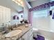 Bathroom featuring a vanity with marble countertop and soaking tub at 25110 Meriweather Rd, Leesburg, FL 34748