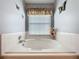 Bright bathroom featuring a soaking tub and natural light at 25110 Meriweather Rd, Leesburg, FL 34748