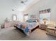 Spacious bedroom with vaulted ceilings, dresser, nightstands, and carpeted floors at 25110 Meriweather Rd, Leesburg, FL 34748