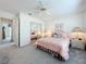 Cozy bedroom featuring a ceiling fan, mirror closet, and comfortable furnishings at 25110 Meriweather Rd, Leesburg, FL 34748