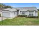 Lovely single-story house with attached garage, manicured lawn, and beautiful curb appeal at 25110 Meriweather Rd, Leesburg, FL 34748