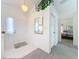 Bright home foyer featuring white walls, tiled floors, and a view into the main bedroom at 25110 Meriweather Rd, Leesburg, FL 34748