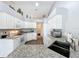 Spacious kitchen with ample granite countertop space, white cabinets, and stainless steel appliances, bright and modern at 25110 Meriweather Rd, Leesburg, FL 34748