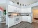 Modern kitchen featuring white cabinets, granite countertops, stainless steel appliances, and lots of natural light at 25110 Meriweather Rd, Leesburg, FL 34748