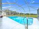 Sparkling pool within a screened enclosure, offering a beautiful backyard view at 25110 Meriweather Rd, Leesburg, FL 34748