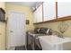 Laundry room with sink, cabinets, and modern washer and dryer at 25265 Lost Oak Cir, Leesburg, FL 34748