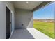 Covered porch with concrete tile, a sliding door, and a view of the yard at 2824 Supermarine Rd, Tavares, FL 32778