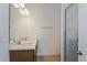 Bright bathroom featuring double sinks, quartz countertop and frameless shower at 2824 Supermarine Rd, Tavares, FL 32778