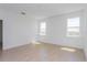 Bright bedroom with two windows and light-colored flooring at 2824 Supermarine Rd, Tavares, FL 32778