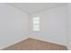 Bedroom with neutral carpet, a window and white walls at 2824 Supermarine Rd, Tavares, FL 32778