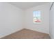 Bedroom with neutral carpet, a window and white walls at 2824 Supermarine Rd, Tavares, FL 32778