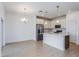 Spacious eat-in kitchen featuring stainless steel appliances, white cabinetry, and modern lighting at 2824 Supermarine Rd, Tavares, FL 32778