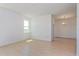 Open-concept living room with tile floors, a large window, and access to dining area at 2824 Supermarine Rd, Tavares, FL 32778