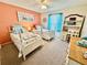 Cozy bedroom with twin beds, nautical themed decor and a peach accent wall at 2910 Barboza Dr, The Villages, FL 32162