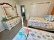 Comfortable bedroom with matching twin beds, dresser with mirror, and closet at 2910 Barboza Dr, The Villages, FL 32162
