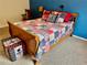 Comfortable bedroom with a blue accent wall and a wooden sleigh bed with colorful quilt at 2910 Barboza Dr, The Villages, FL 32162