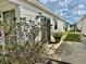 Exterior view of the side of the house, lanai and a glimpse of a white picket fence at 2910 Barboza Dr, The Villages, FL 32162