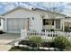 Charming single-story home with white picket fence and well-maintained landscaping at 2910 Barboza Dr, The Villages, FL 32162