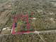 Expansive property showcasing a house surrounded by lush greenery and a serene pond, all within a private, wooded lot at 2930 Cr 416N, Lake Panasoffkee, FL 33538