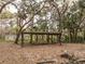 Covered carport area, surrounded by mature trees and foliage at 2930 Cr 416N, Lake Panasoffkee, FL 33538