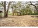 Open carport surrounded by foliage at 2930 Cr 416N, Lake Panasoffkee, FL 33538