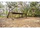 Open carport surrounded by foliage and trees at 2930 Cr 416N, Lake Panasoffkee, FL 33538