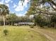 Secluded two-story home surrounded by lush greenery, offering privacy and tranquility in a peaceful setting at 2930 Cr 416N, Lake Panasoffkee, FL 33538