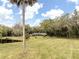 Long ranch home boasts mature landscaping and a private pond on pristine acreage at 2930 Cr 416N, Lake Panasoffkee, FL 33538