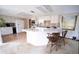 Bright kitchen with white cabinetry, a large island, and vintage flooring at 2930 Cr 416N, Lake Panasoffkee, FL 33538
