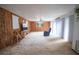 Spacious living room features wood-paneled walls, a ceiling fan, and a large window at 2930 Cr 416N, Lake Panasoffkee, FL 33538