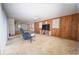 Spacious living room with classic wood paneling, cozy chair, and bright, natural light at 2930 Cr 416N, Lake Panasoffkee, FL 33538