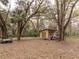 Exterior view of outbuilding, surrounded by mature trees and foliage at 2930 Cr 416N, Lake Panasoffkee, FL 33538