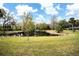 Scenic view of a serene pond surrounded by lush greenery and trees at 2930 Cr 416N, Lake Panasoffkee, FL 33538