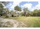 Sprawling property featuring a two-story home surrounded by lush greenery and mature trees at 2930 Cr 416N, Lake Panasoffkee, FL 33538