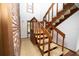 Carpeted staircase with wood railings, offering a warm and inviting transition between floors in the home at 2930 Cr 416N, Lake Panasoffkee, FL 33538