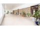 Spacious sunroom with brick wall, many windows, and neutral floor at 2930 Cr 416N, Lake Panasoffkee, FL 33538