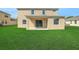 Expansive backyard featuring a covered patio and ample green space for outdoor activities at 30342 Gidran Ter, Mount Dora, FL 32757