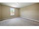 Light-filled bedroom featuring neutral carpet and walls, and a window with a pleasant view at 30342 Gidran Ter, Mount Dora, FL 32757