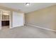 Bedroom with sliding closet doors and an en-suite bathroom with dark wood vanity at 30342 Gidran Ter, Mount Dora, FL 32757
