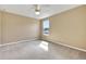 Cozy bedroom featuring neutral walls and carpet, ceiling fan, and window at 30342 Gidran Ter, Mount Dora, FL 32757