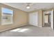 Bright and spacious bedroom with a ceiling fan, closet, and neutral carpet flooring at 30342 Gidran Ter, Mount Dora, FL 32757