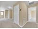Hallway featuring neutral walls, carpet flooring, and access to rooms and closets at 30342 Gidran Ter, Mount Dora, FL 32757