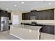 Open kitchen boasts a center island, stainless steel appliances, and dark wood cabinets at 30342 Gidran Ter, Mount Dora, FL 32757