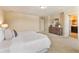 Spacious main bedroom with a large bed, dresser, and carpet flooring at 30342 Gidran Ter, Mount Dora, FL 32757
