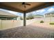 Covered back porch has a ceiling fan and a decorative brick patio, perfect for outdoor relaxation and entertainment at 3139 Hurston Watch Ln, Clermont, FL 34711