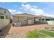 Spacious backyard with a paver patio, fire pit, storage shed, and well-kept landscaping, great for outdoor activities at 3139 Hurston Watch Ln, Clermont, FL 34711
