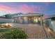 Beautiful backyard with a cozy fire pit, brick paver patio, and landscaped areas, ideal for relaxation and entertaining at 3139 Hurston Watch Ln, Clermont, FL 34711